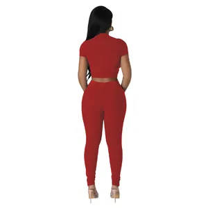 Back view of red ribbed two-piece activewear set featuring crop top and long leggings