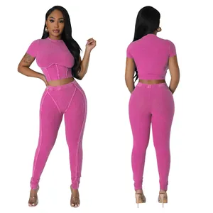 Front and back view of rose pink ribbed knit two-piece athletic crop top and leggings set