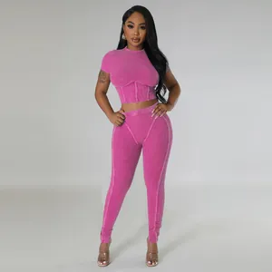 Two-piece ribbed sports set featuring a short sleeve crop top and matching leggings in pink