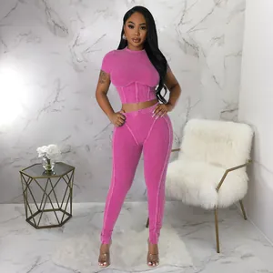 Detailed view of hot pink ribbed two-piece set with crop top and tight leggings