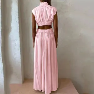 Back view of pink two-piece set with mock neck crop top and cut-out maxi skirt