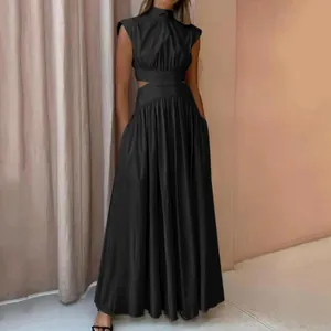 Detail showing elegant black sleeveless maxi dress with waist cut-outs and pleated skirt