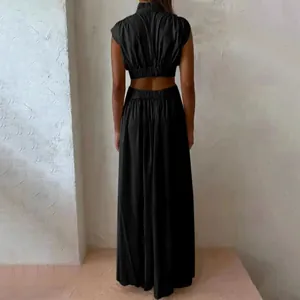Rear view of elegant black cutout maxi dress with high waist and backless design.