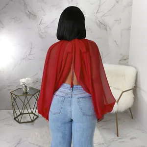 Vista posteriore di un'elegante camicetta rossa in chiffon con maniche a pipistrello e fiocco