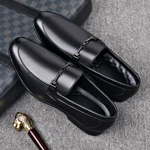 Detail view of premium black leather business loafers for men with metal buckle