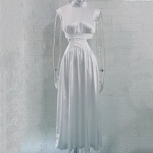 Detail showing the waist cutout and satin texture of the white mock neck maxi dress.