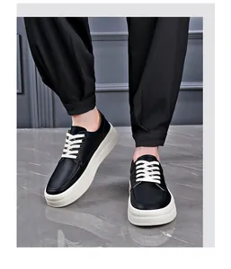 Close-up view of stylish black leather platform sneakers for men being worn by a model