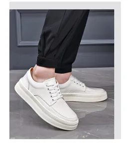 Macro view of men's white genuine leather platform sneakers with lace-up design