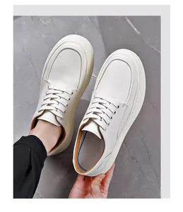 Top view of white leather men's casual shoes showing thick sole and lace-up detail