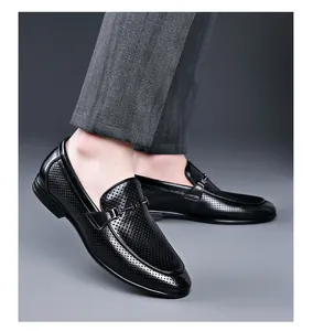 Close-up of black perforated leather loafers for men in a professional setting
