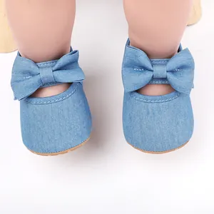 Vista detallada de zapatos para bebé niña en denim azul claro con elegante lazo decorativo