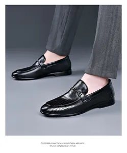 Detailed view of breathable perforated black leather loafers for men's business wear.