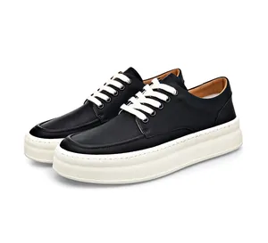 Detailed view of men's black leather casual shoes with thick white soles and laces