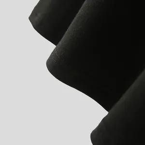 Macro view of the stitching and soft knit fabric on a black men's short-sleeve T-shirt
