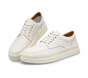 Close-up view of men's off-white thick-sole leather sneakers with white laces