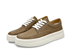 Detailed view of men's brown leather platform shoes featuring thick white soles and laces