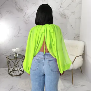 Vista posteriore della camicetta in chiffon verde neon con maniche a pipistrello e fiocco