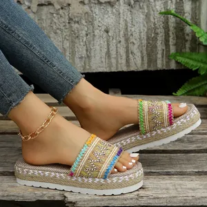 Ethnic style bohemian platform slide sandals with colorful woven straps shown on model