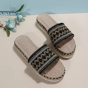 Detailed view of women's ethnic platform sandals with embroidered straps and hemp rope sole