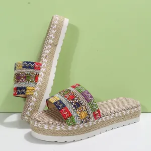 Detail of ethnic style women's platform espadrille slides with woven colorful strap