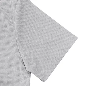 Detailed close-up of gray heavy waffle knit fabric and sleeve on men's Polo shirt