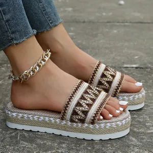 Close-up of ethnic style woven strap and rope-wrapped platform sole on sandals