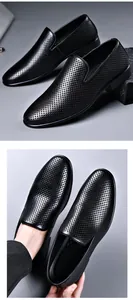 Detail view of black perforated genuine leather men's slip-on business shoes.