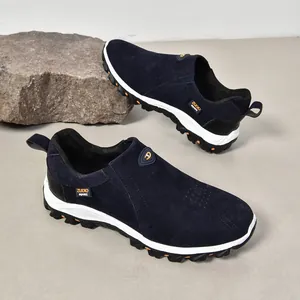 Chaussures outdoor bleues en daim pour hommes, présentées sur un décor de roche naturelle.