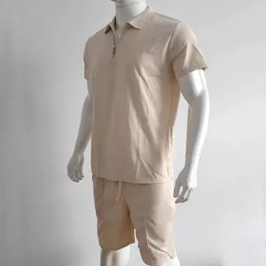 Detailed view of men's beige short sleeve zip polo and matching shorts with waffle texture