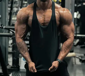 Close-up of premium black cotton stringer tank top worn by a muscular male athlete