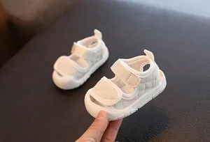 Close-up detail of soft-sole baby walking sandals with quilted pattern and Velcro straps.