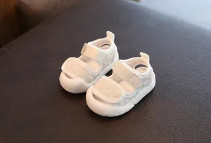 Detail view of white quilted baby sandals with soft soles and velcro straps