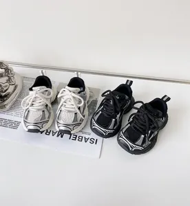 Close-up view of stylish kids' chunky sneakers in black and white silver colors