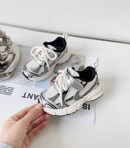 Close-up of stylish baby sneakers in silver and white with soft soles for toddlers