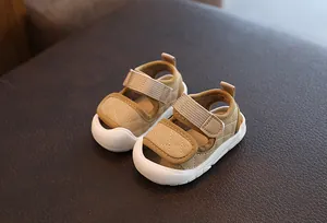 Macro view of beige baby sandals featuring quilted pattern and non-slip soft white soles.