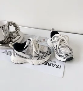 Silver and white toddler sneakers with breathable mesh and soft thick textured soles
