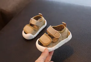 Close-up of khaki baby sandals with soft non-slip soles for summer