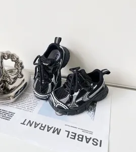 Detail of toddler sports shoes with black mesh and white graphic patterns.