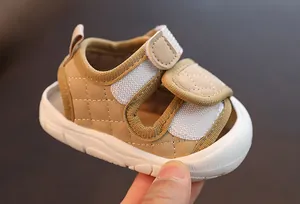 Detailed view of khaki baby walking sandals with soft non-slip sole and Velcro straps