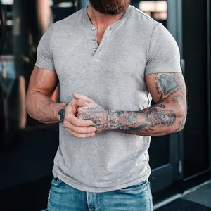 Close-up detail of men's casual grey short sleeve Henley t-shirt with buttoned neckline