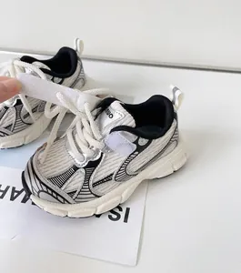 Close-up of children's white and silver sporty sneakers with velcro strap