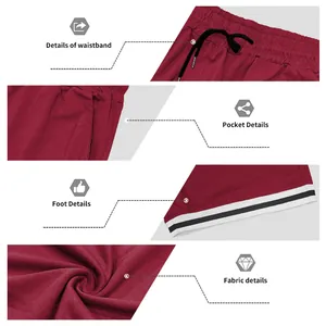 Dettagli ravvicinati dei pantaloncini sportivi bordeaux con vita, tasche e orlo a righe.