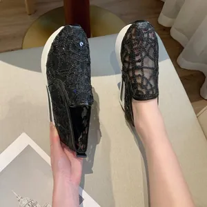 Nahaufnahme schwarzer Mesh-Plateau-Sneaker mit glitzernden Pailletten-Stickereien