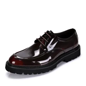 Vista detallada de un zapato Derby de charol burdeos con suela negra gruesa.