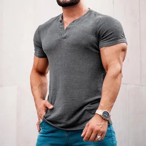 Close-up view of men's charcoal grey short-sleeved Henley shirt with button placket