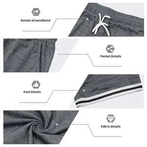 Dettagli dei pantaloncini sportivi grigi da uomo con elastico e orlo a righe.