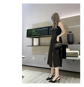 Woman wearing black tweed slingback pointed-toe kitten heels in a modern interior setting