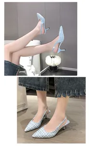 Macro view showing the elegant light blue tweed fabric on these pointed toe kitten heels