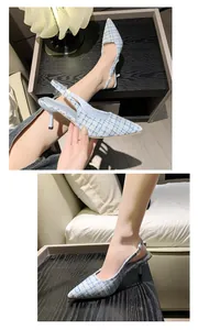 Detailed close-up of elegant light blue tweed pointed toe slingback kitten heels