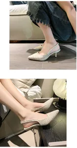 Detailed close-up of French style beige tweed pointed toe slingback kitten heels.
